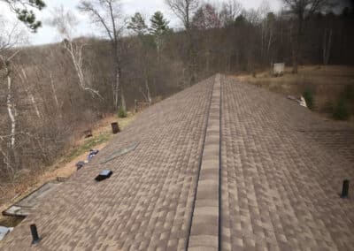 Residential roof completed with brown asphalt shingles