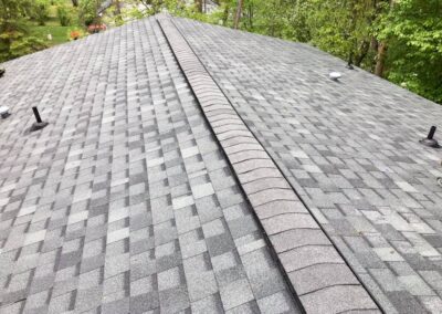 Residential roof completed with gray asphalt architectural shingles