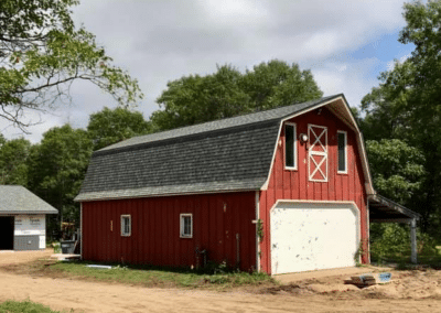 Residential asphalt shingles roof replacement completed on red barn