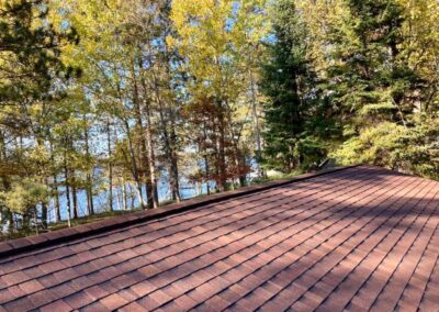 Residential roof completed with red architectural asphalt shingles