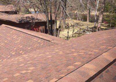 Asphalt roof replacement completed with red architectural shingles
