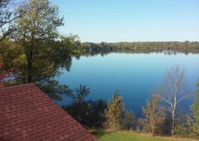 Residential asphalt shingles roof replacement completed on lake home