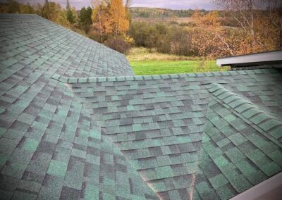 Asphalt roof replacement completed with green architectural shingles