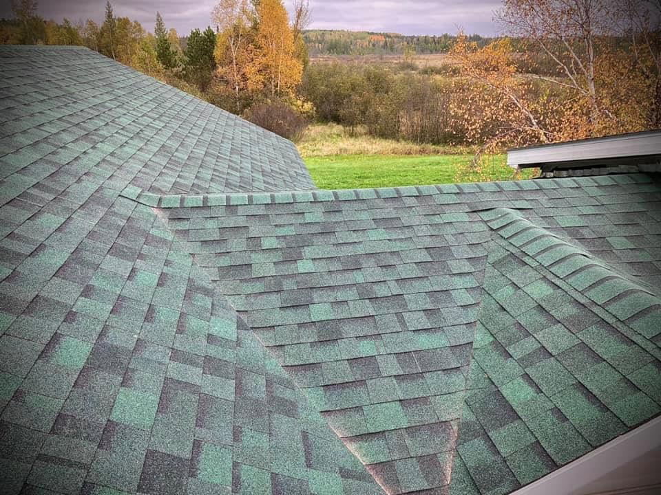 Asphalt roof replacement completed with green architectural shingles