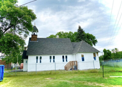 Asphalt roofing job completed on white church building