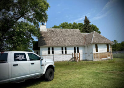 Asphalt roofing job for white church building-before work started