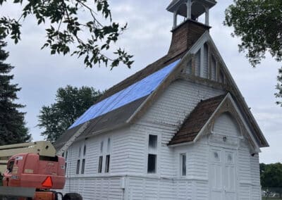 Asphalt shingles white church roofing job in progress