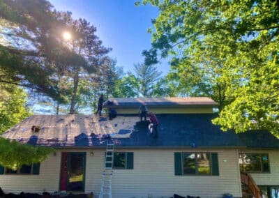 Residential asphalt shingles roof replacement in progress with brown architectural shingles