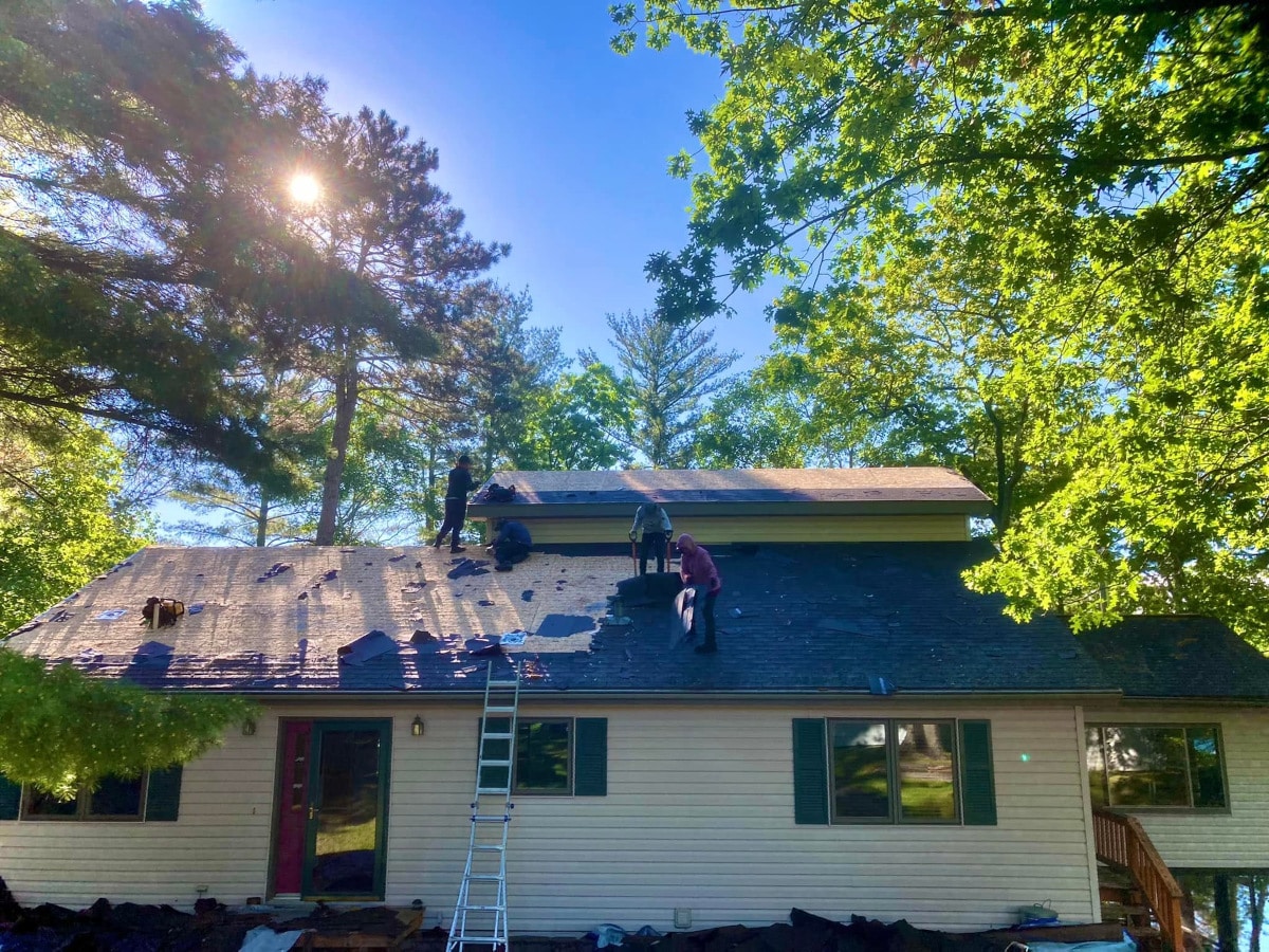 Residential asphalt shingles roof replacement in progress with brown architectural shingles