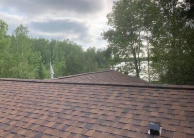 Residential roof replacement with red asphalt shingles