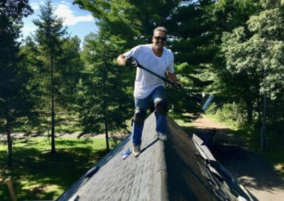 asphalt roof project with Robert Aguirre on top of roof working