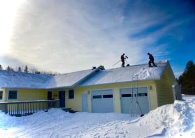 Roof snow removal almost complete on home