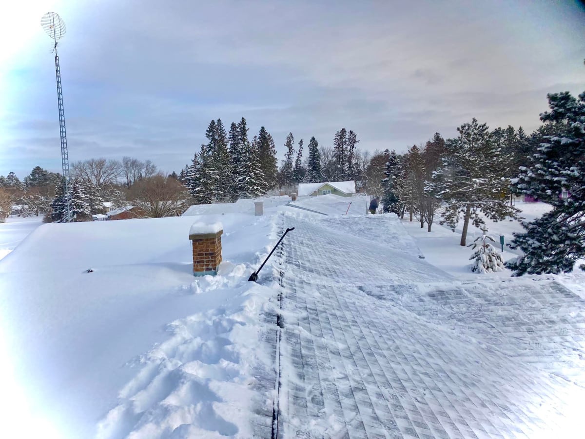 Deep snow on shingles roof in Brainerd Lakes area