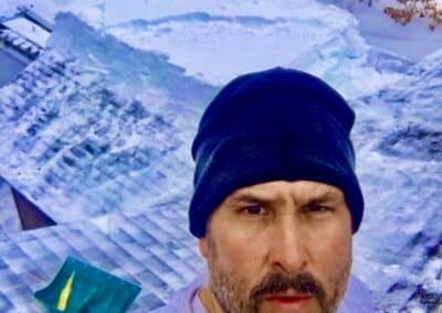 Roof snow removal job in progress with Robert