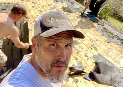 Robert Aguirre working on roof replacement project with team