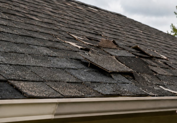 Roof showing damage after a storm graphic