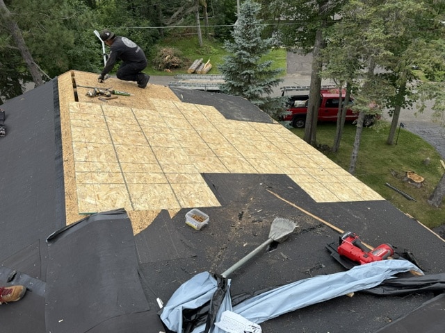 Asphalt roof replacement-project in progress showing decking and underlayment in Lakeshore MN