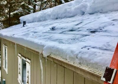 Roof snow and ice clearing on residential home in progress