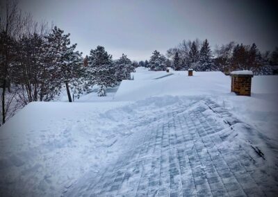 Roof snow removal on residential home in progress